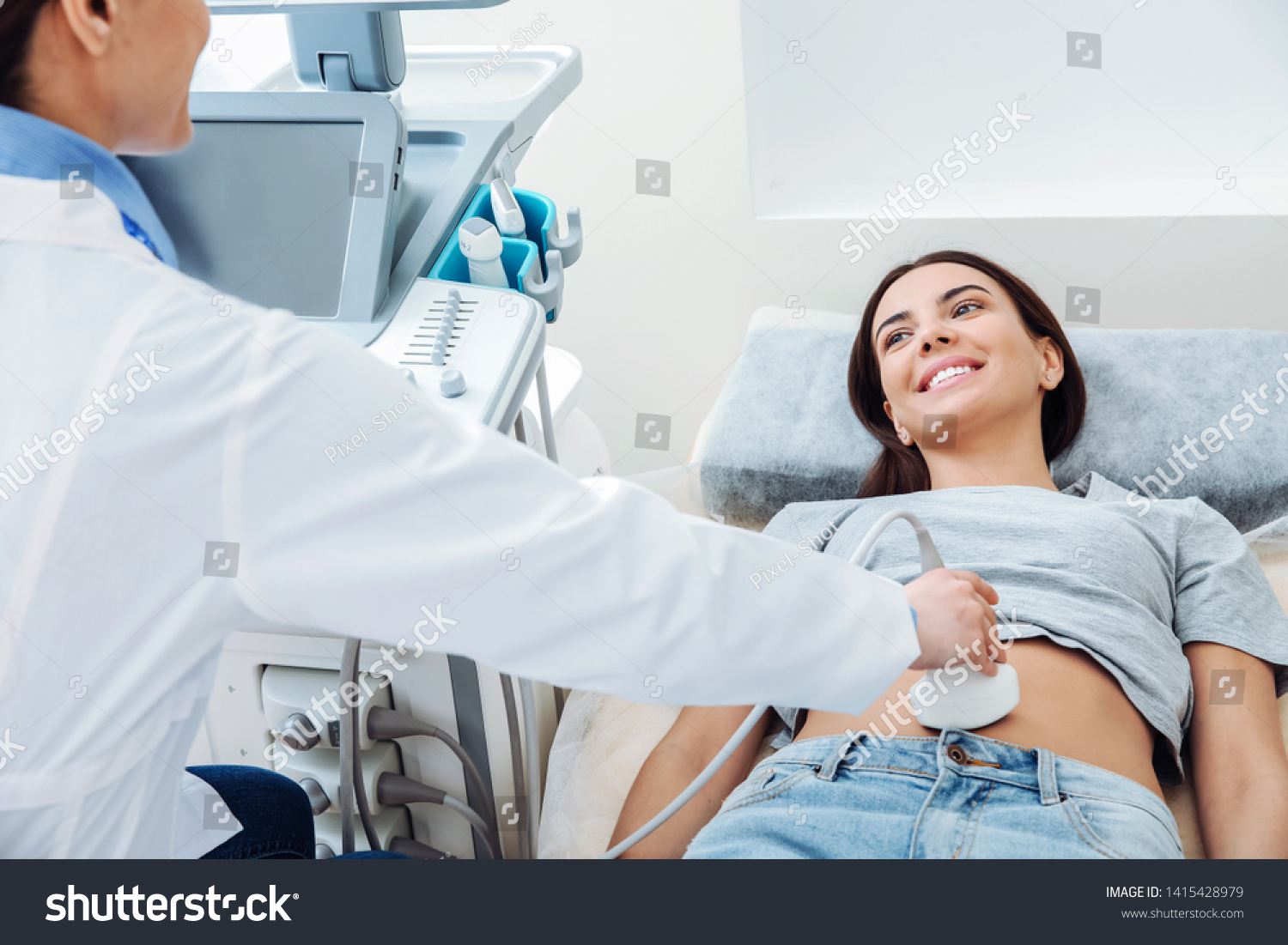 Woman undergoing ultrasound scan in clinic #1415428979