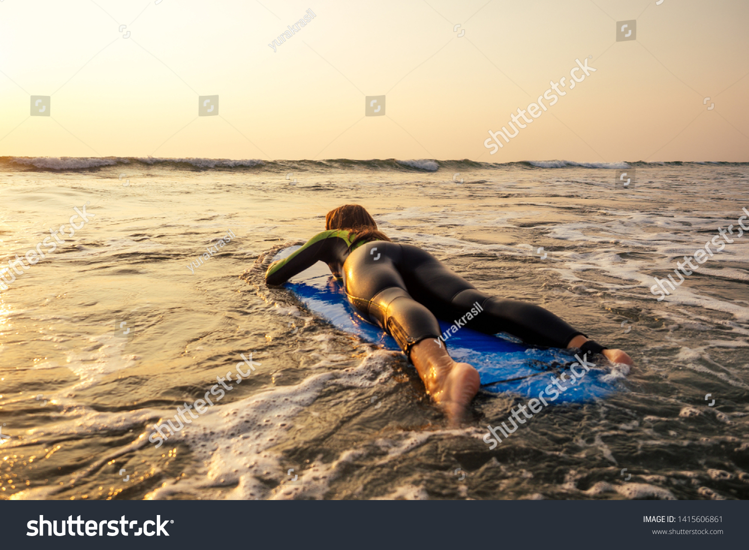 active women with surf board enjoy watersport at vacation holidays.sport girl in surfing school instructor of windsurf. tourist female model in a diving suit wetsuit on the beach in the Indian Ocean #1415606861