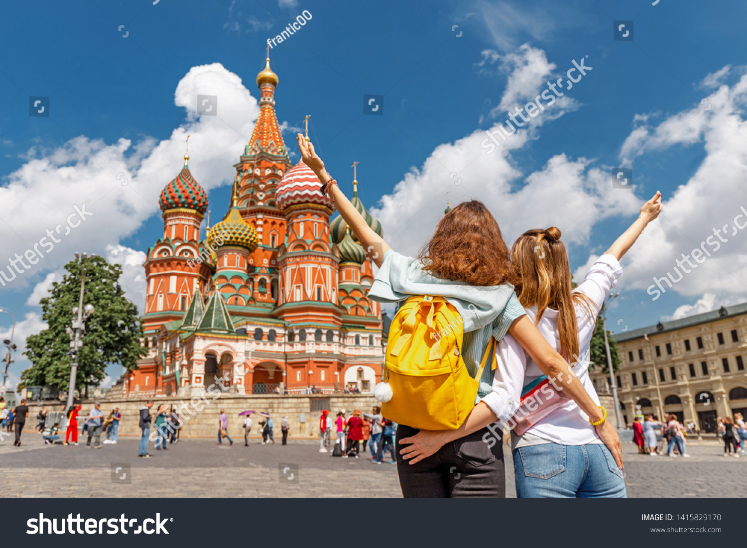 Two happy young happy girls travels in Russia and taking selfie in front of the St Basil Cathedral #1415829170