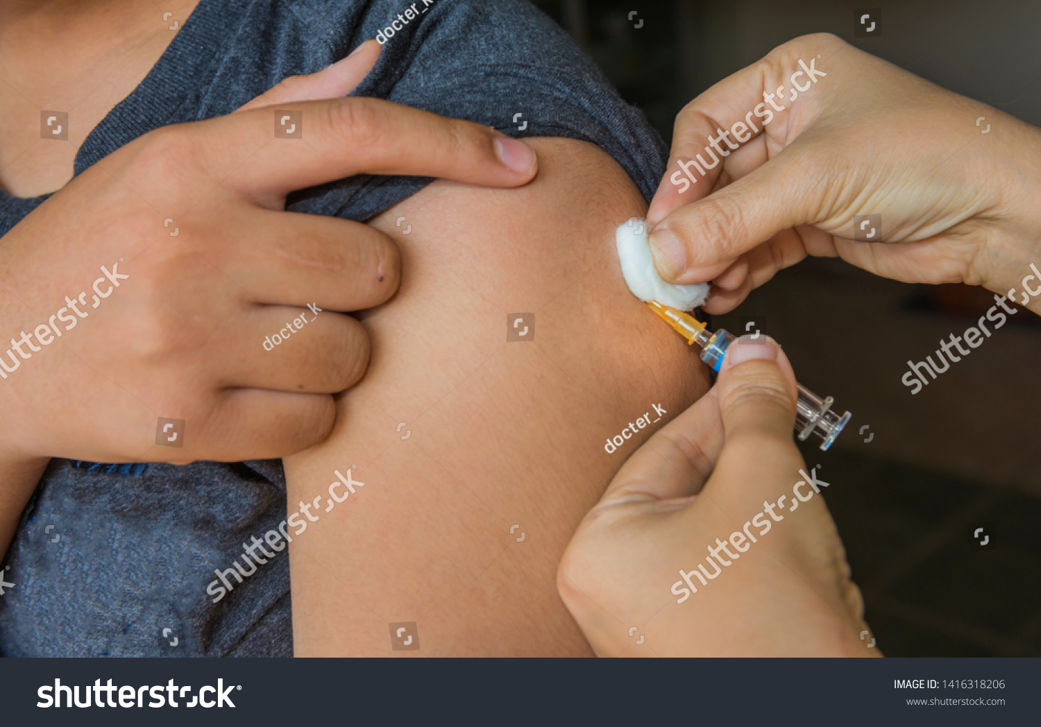 Nurse are vaccinations to patients using the syringe.Doctor vaccinating women in hospital.Are treated by the use of sterile injectable upper arm.injection,antibody,influenza vaccine image. #1416318206