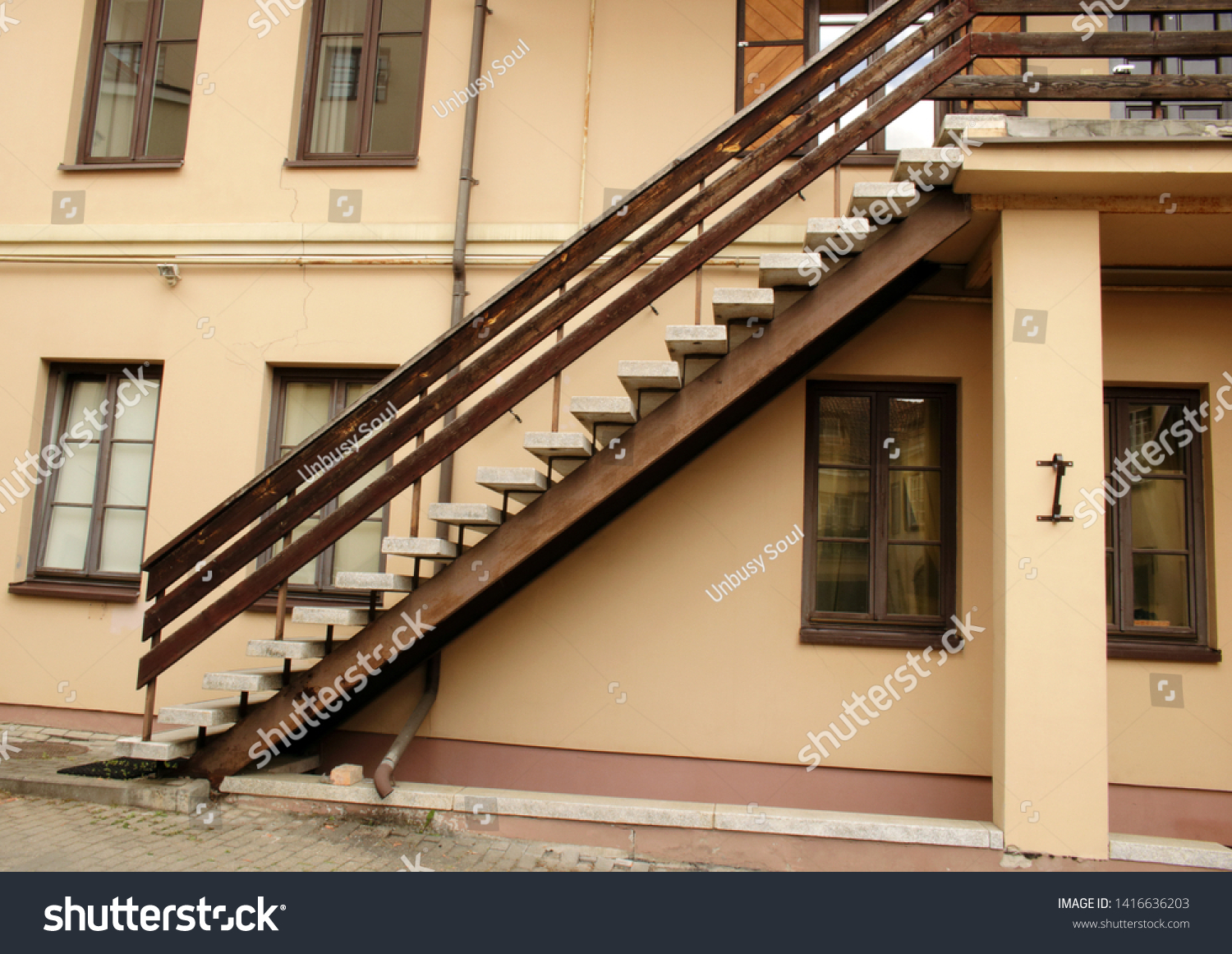 Dark stairway up on light beige wall #1416636203