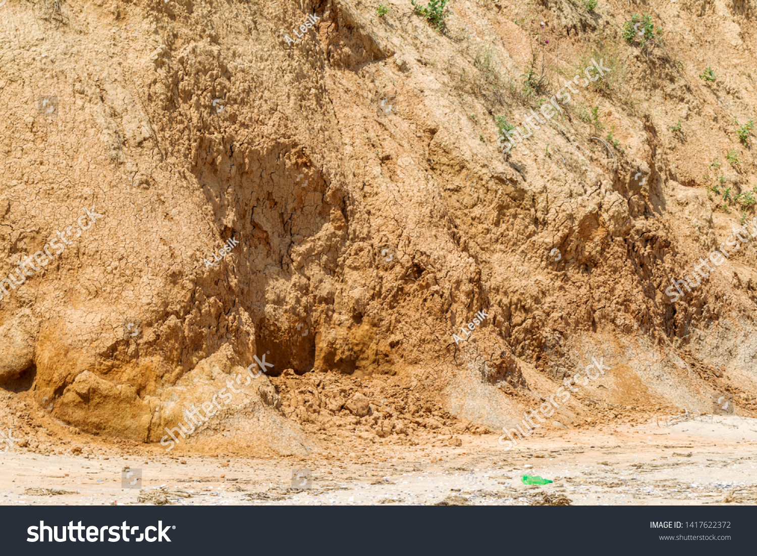 Landslide zone on Black Sea coast. Rock of sea rock shell. Zone of natural disasters during rainy season. Large masses of earth slip along slope of hill, destroy houses. Landslide - threat to life #1417622372