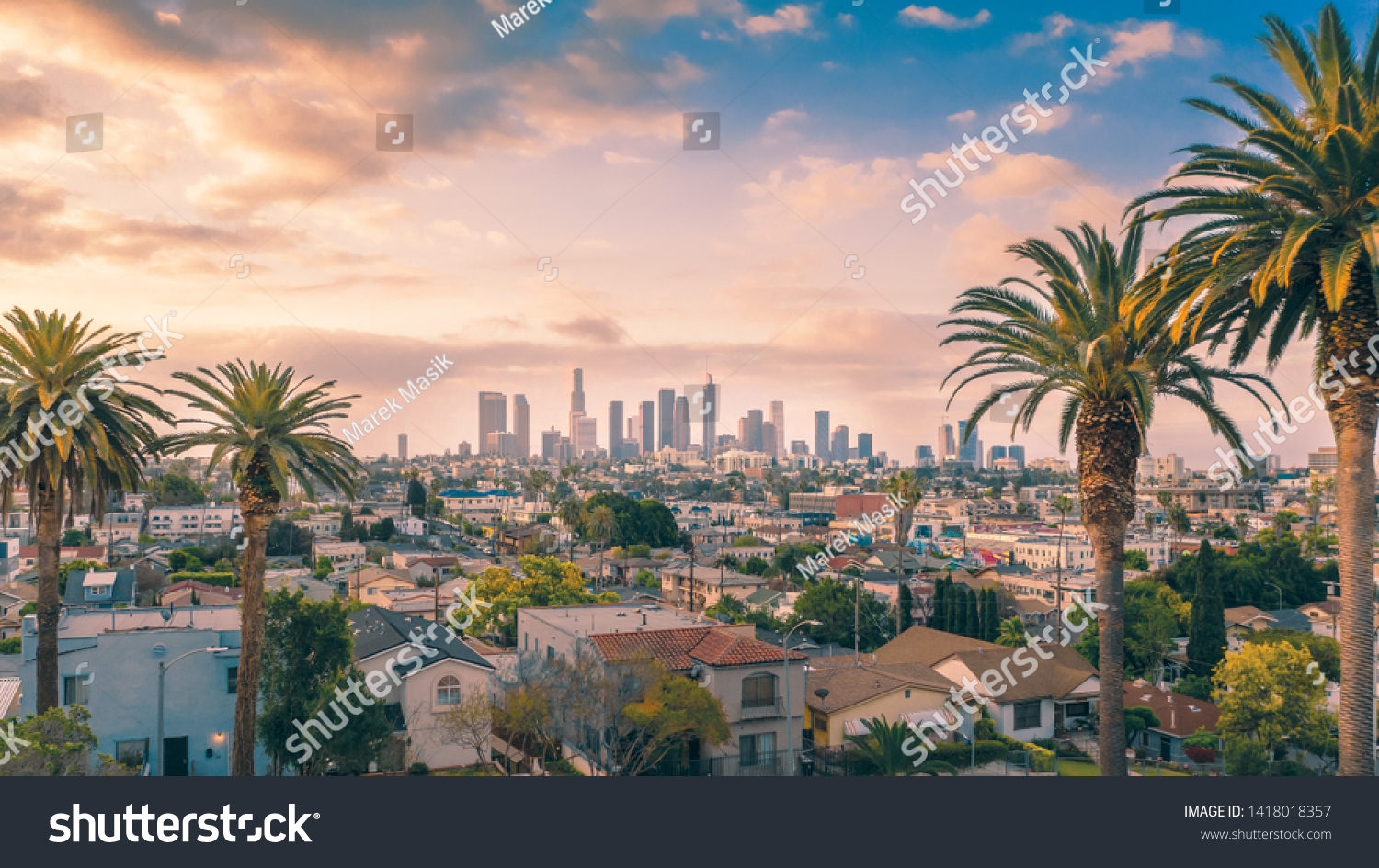 Beautiful sunset of Los Angeles downtown skyline and palm trees #1418018357