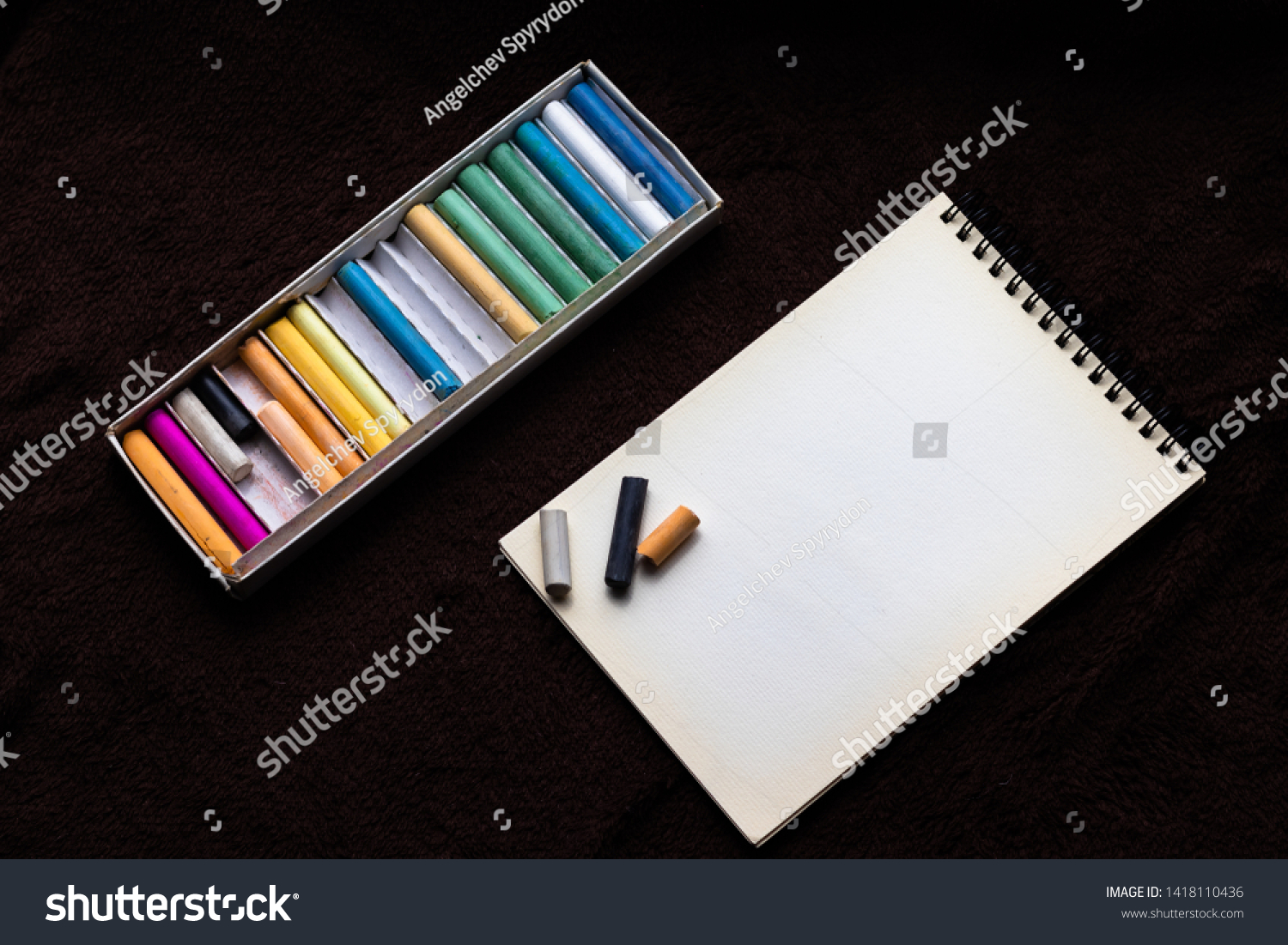 Colored crayons dry pastels and notebook for pastels on a black background #1418110436
