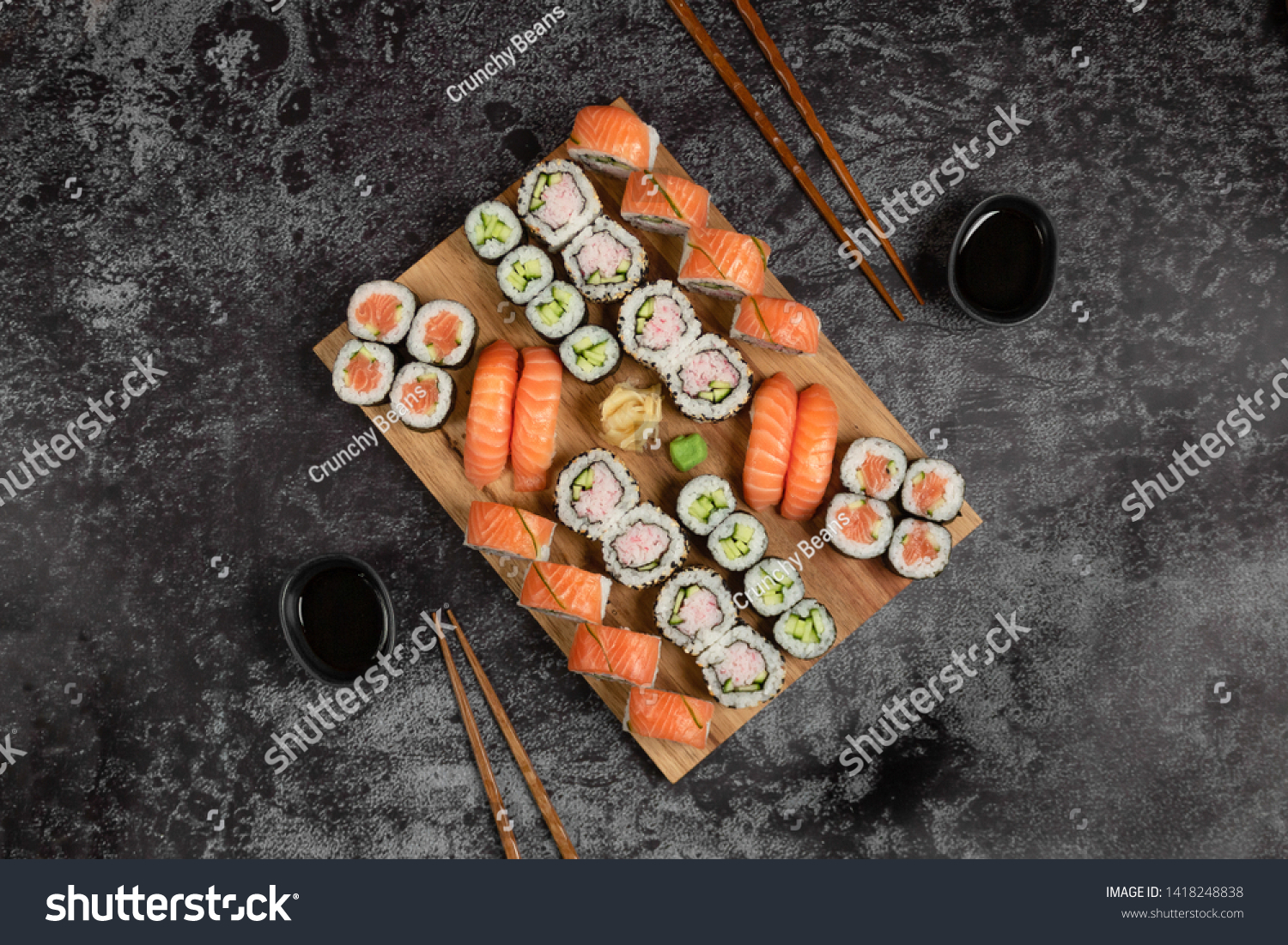 Sushi set of nigiri and maki rolls served on wooden board. Japanese food. Top view  #1418248838