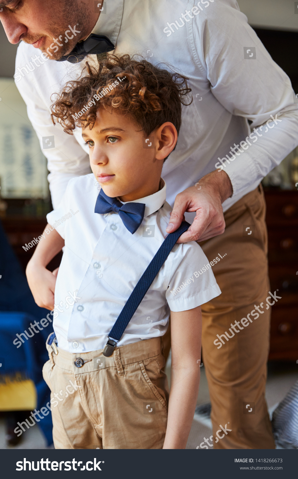 Father And Son Wearing Matching Outfits Getting Ready For Wedding At Home #1418266673