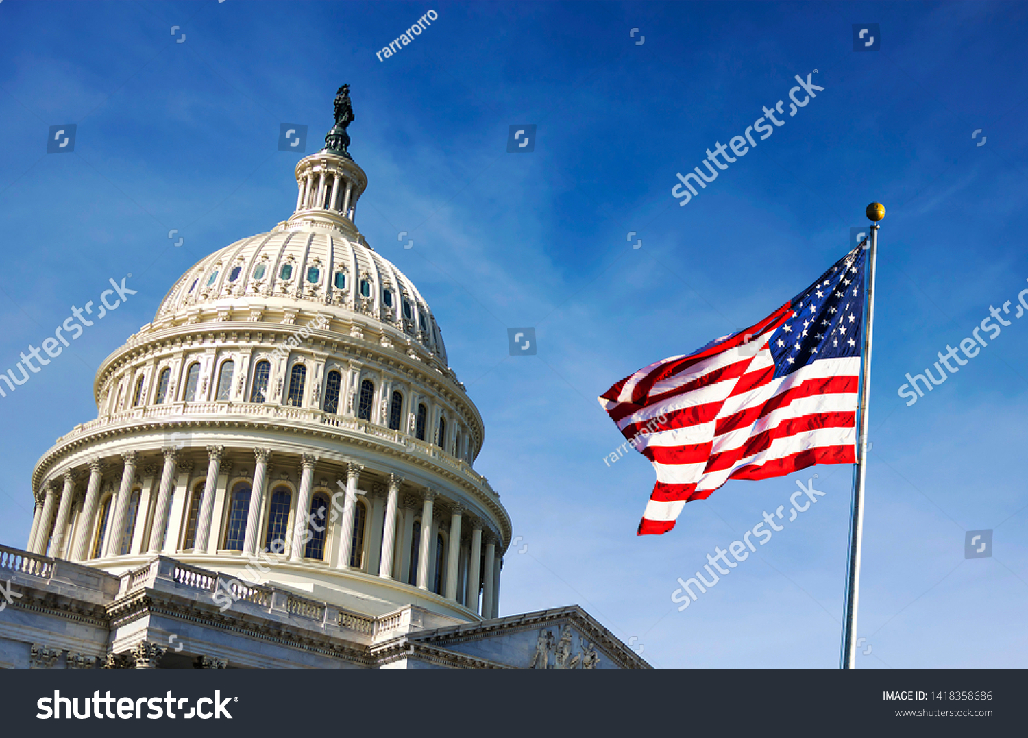 American flag waving with the Capitol Hill in the background #1418358686