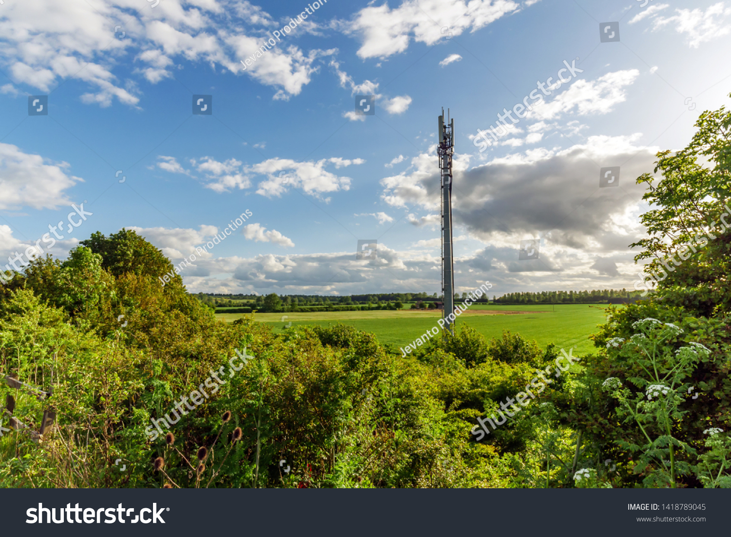 Sunset view British Mobile Operator Mast over field #1418789045
