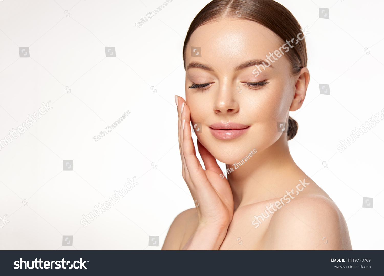 Beautiful young woman with clean fresh skin on face . Girl facial  treatment   . Cosmetology , beauty  and spa .
 #1419778769