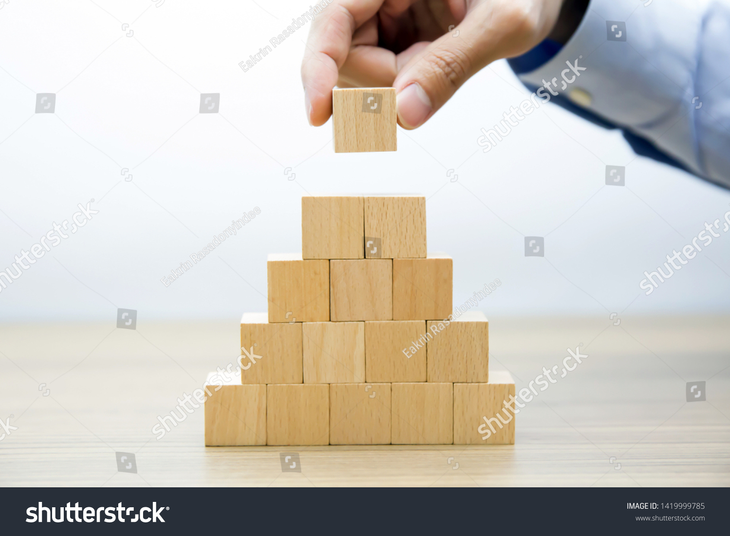 Middle 
Fifteen Wooden cube Stacked in 
Pyramid shape  without graphics for Business and design concept, Symbol of leadership, Teamwork and Growth. #1419999785
