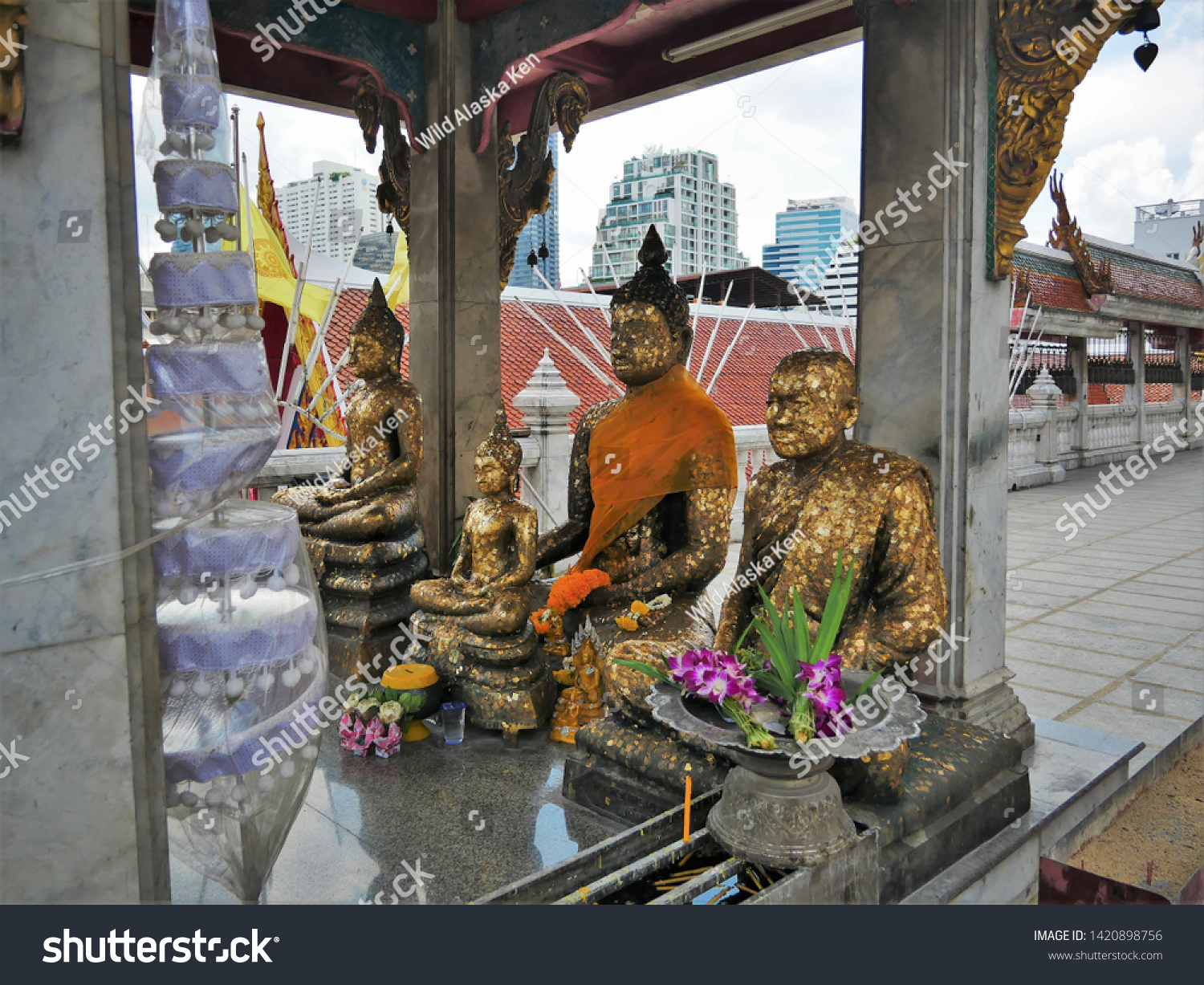 Buddha Statues in Wat Hua Lamphong, Bangkok, Thailand with Bangkok Skyline in the background #1420898756