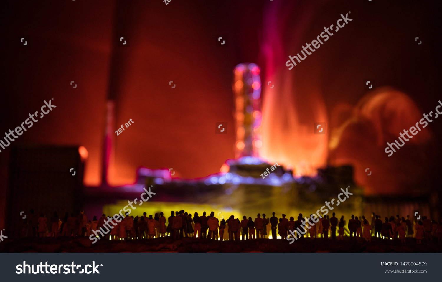 Creative artwork decoration. Chernobyl nuclear power plant at night. Layout of abandoned Chernobyl station after nuclear reactor explosion. Crowd looking on burning reactor. Selective focus #1420904579