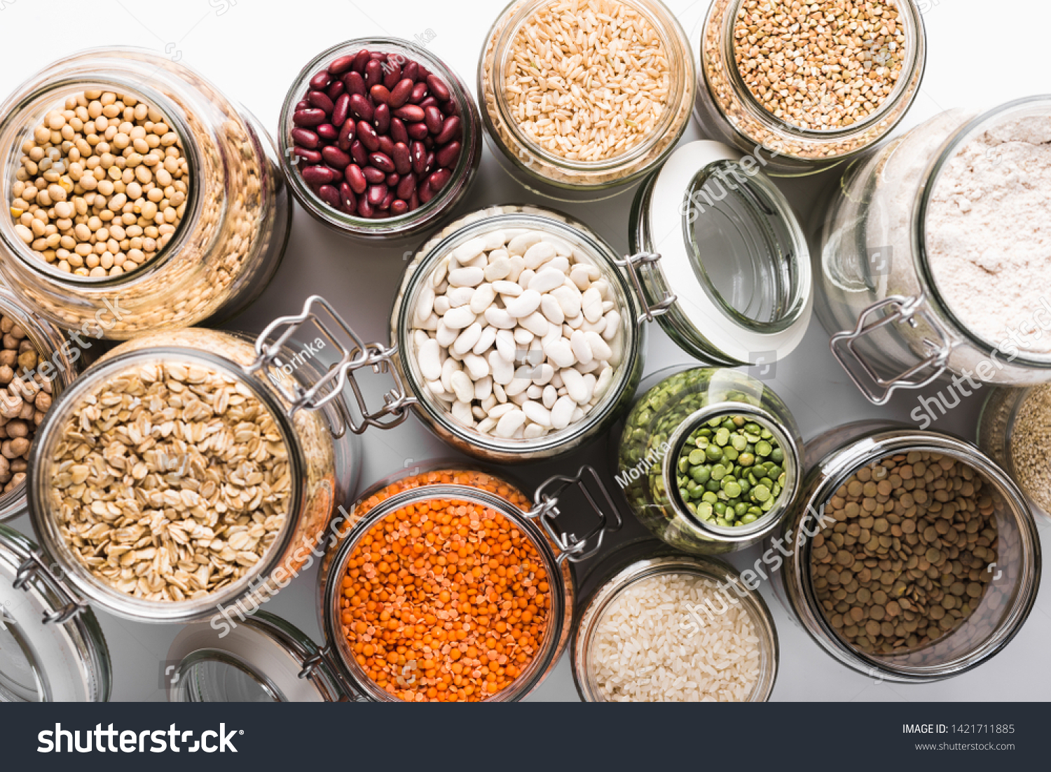 Variety of grains and legumes in glass jars, top view. Zero waste storage concept #1421711885