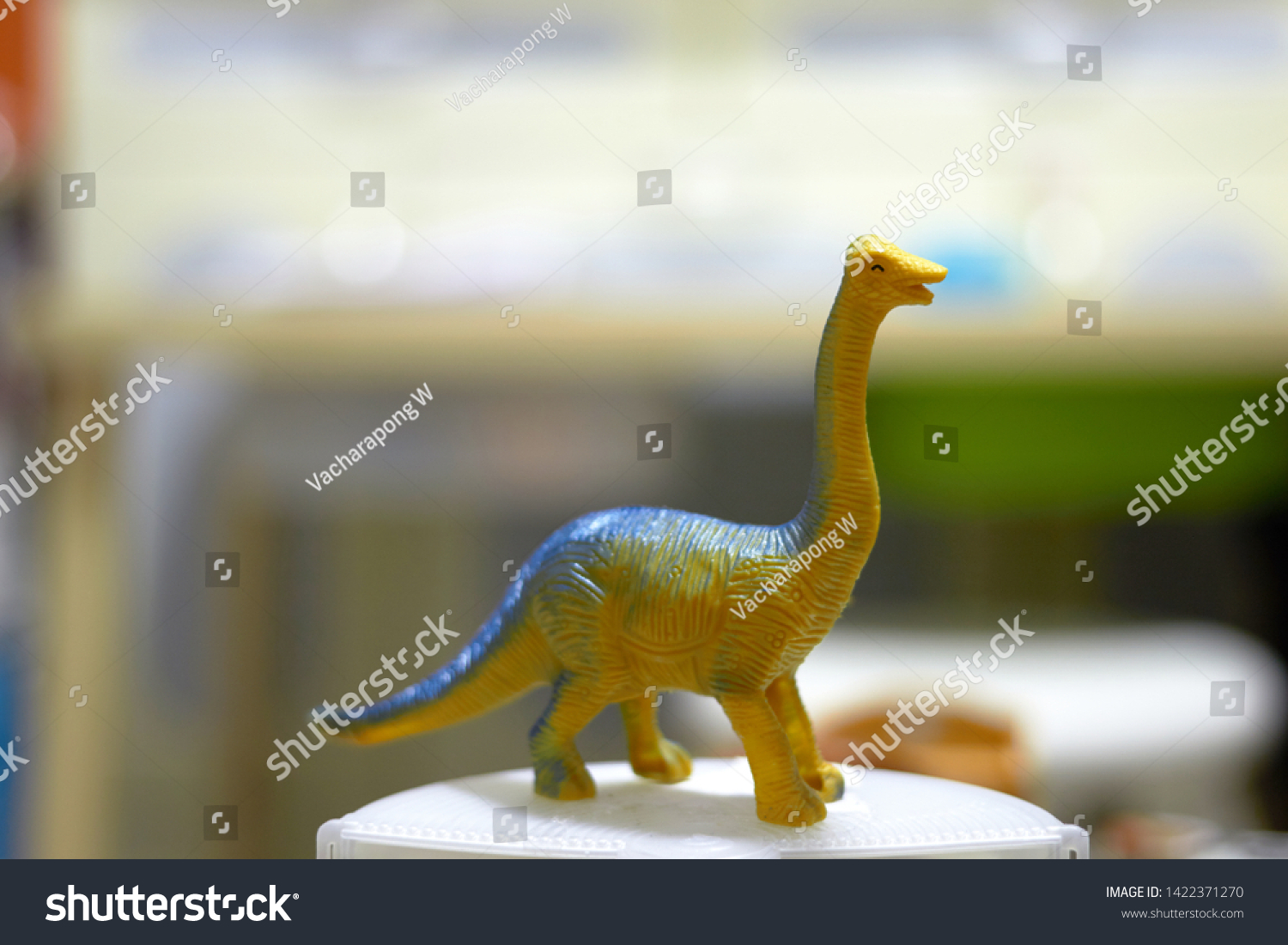 long neck tall Dinosaur toy figure on blur background #1422371270