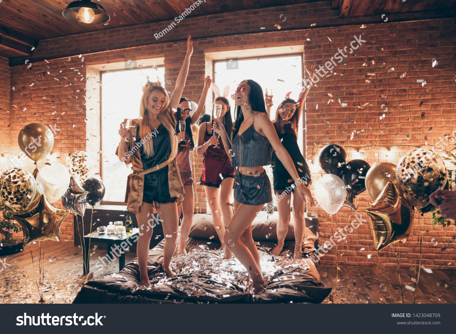 Full length body size view of nice attractive feminine lovely royal cheerful group having fun dancing on bed birthday in open space golden decorated loft industrial style interior room #1423048709