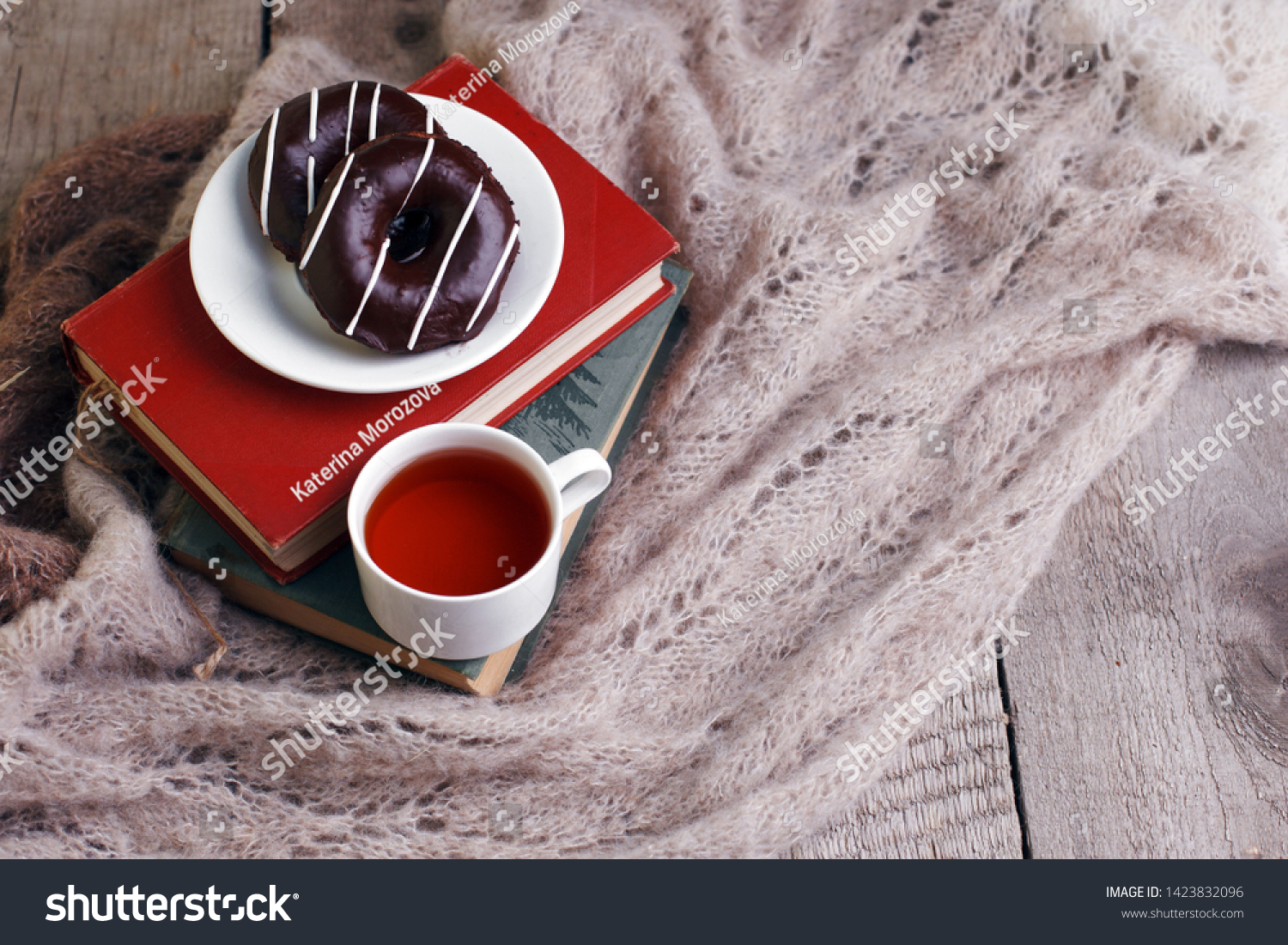 still life a cup of tea with an open book on a wooden table, the concept of coziness and reading, Cozy autumn winter leisure time #1423832096