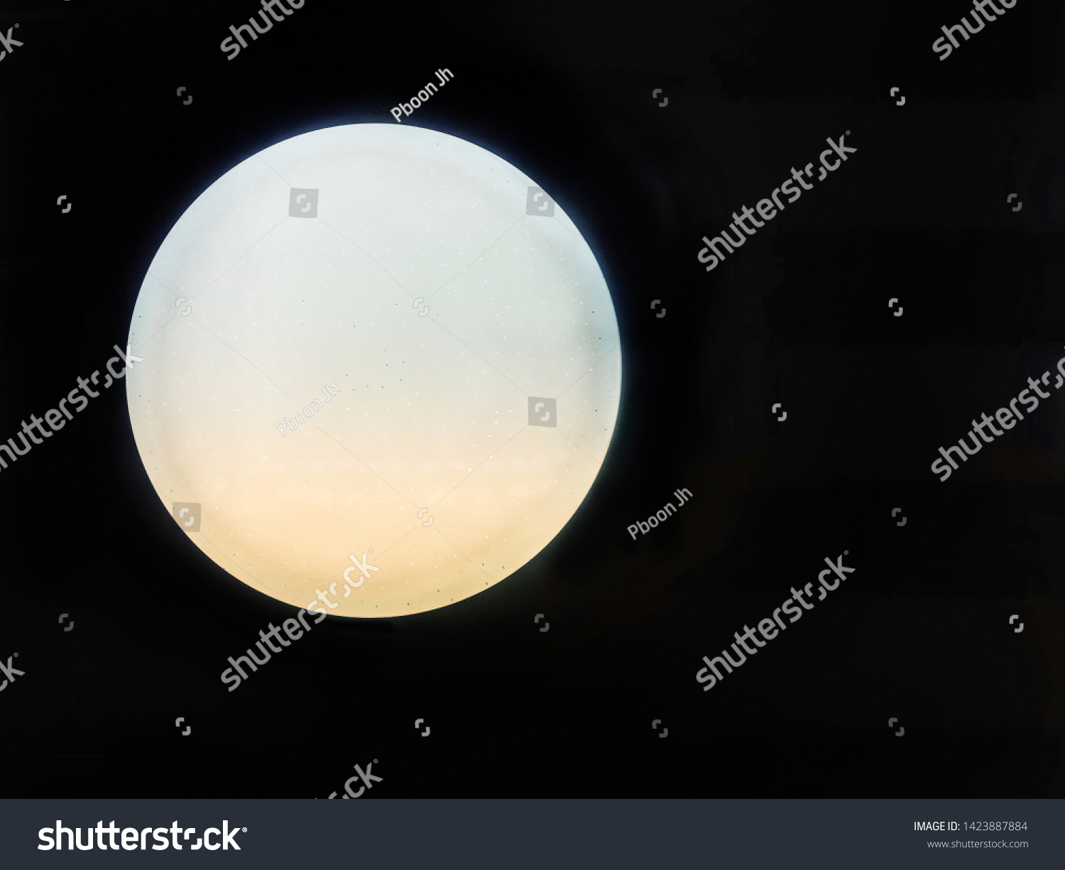 Blurred and defocused image of Glass globe shaped ball ceiling lamps on ceiling background. 
Modern lamps, color change LED bulbs. Moon illustration concept. #1423887884