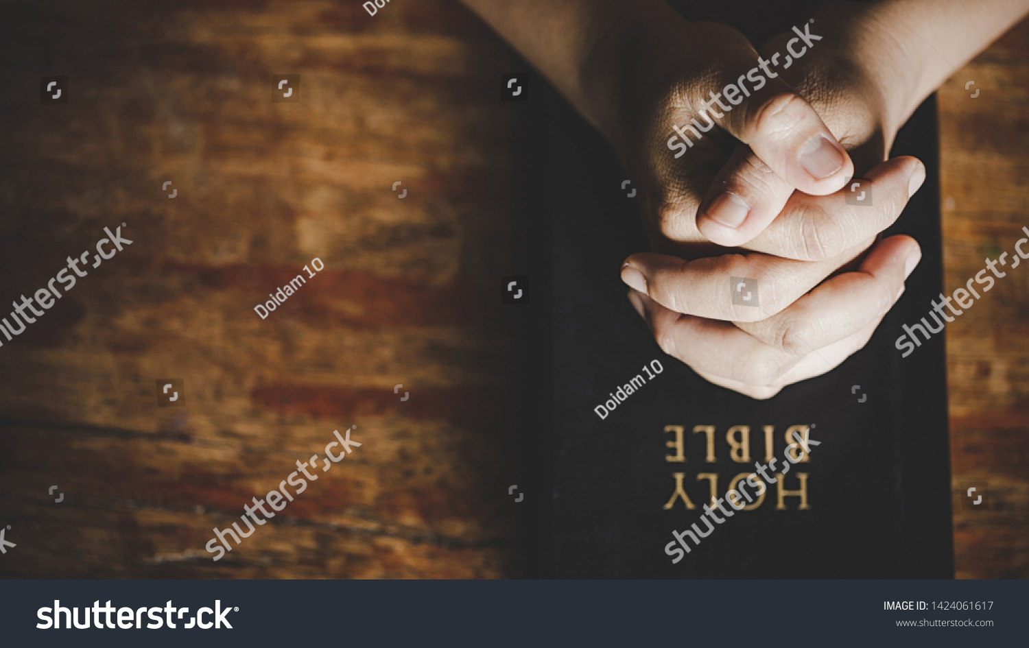 Christian life crisis prayer to god. Woman Pray for god blessing to wishing have a better life. woman hands praying to god with the bible. begging for forgiveness and believe in goodness.  #1424061617