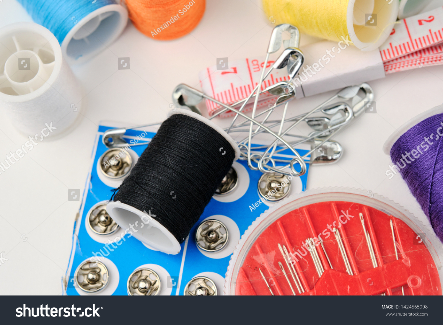 a set of sewing accessories for repairing clothes on a white background close-up #1424565998