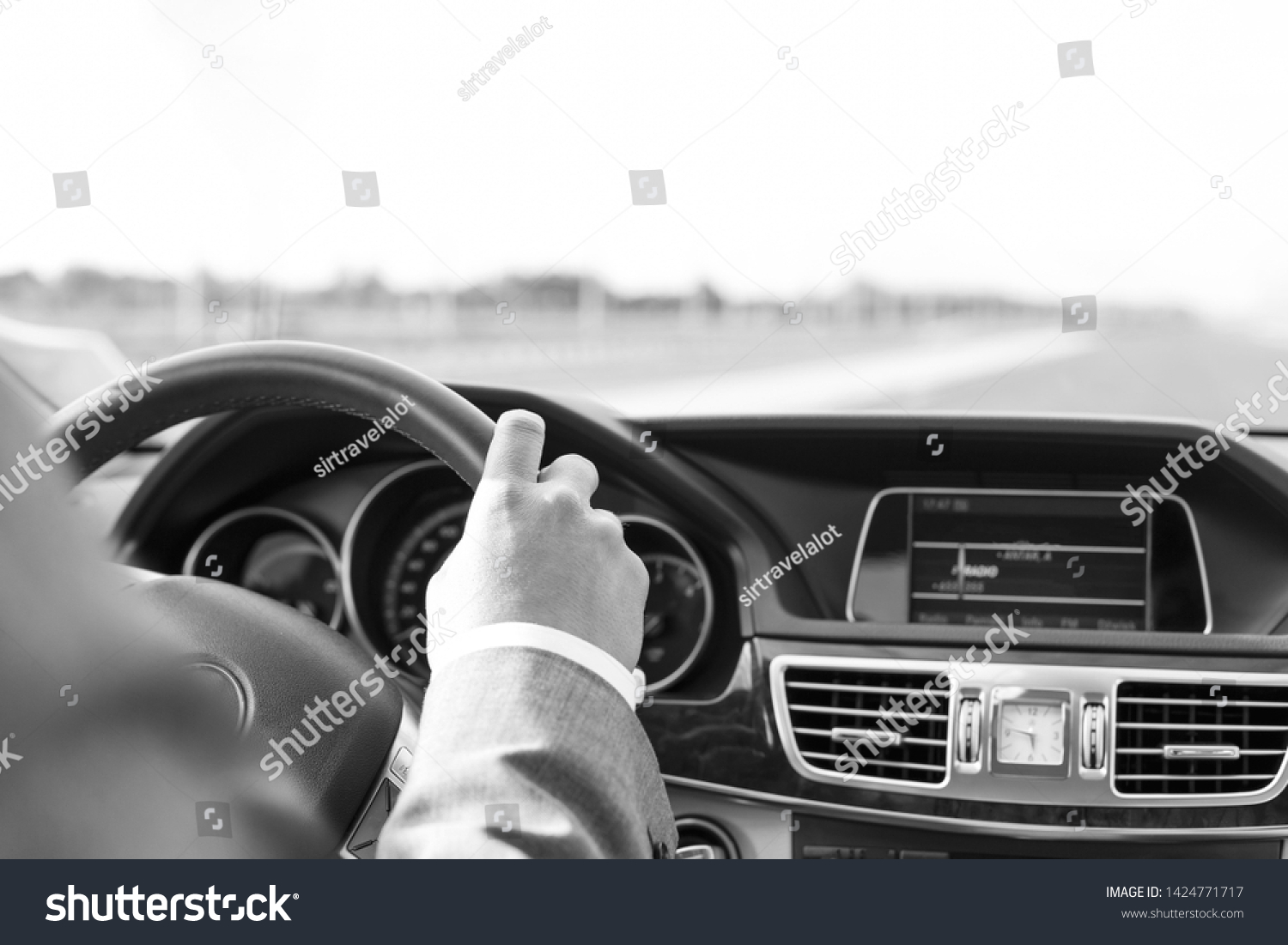Black and White photo of Cropped image of businessman in formals driving car #1424771717