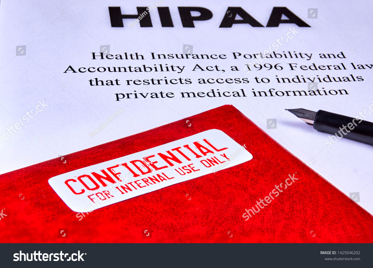 Health Insurance Portability and accountability act HIPAA, red folder with inscription confidential and pen. Close-up #1425046202