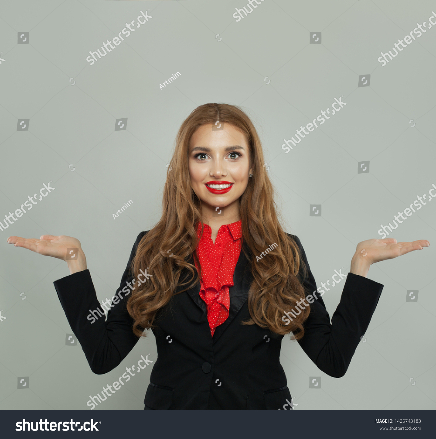 Successful woman holding two empty open hand on white background. Rate, weigh and represent #1425743183