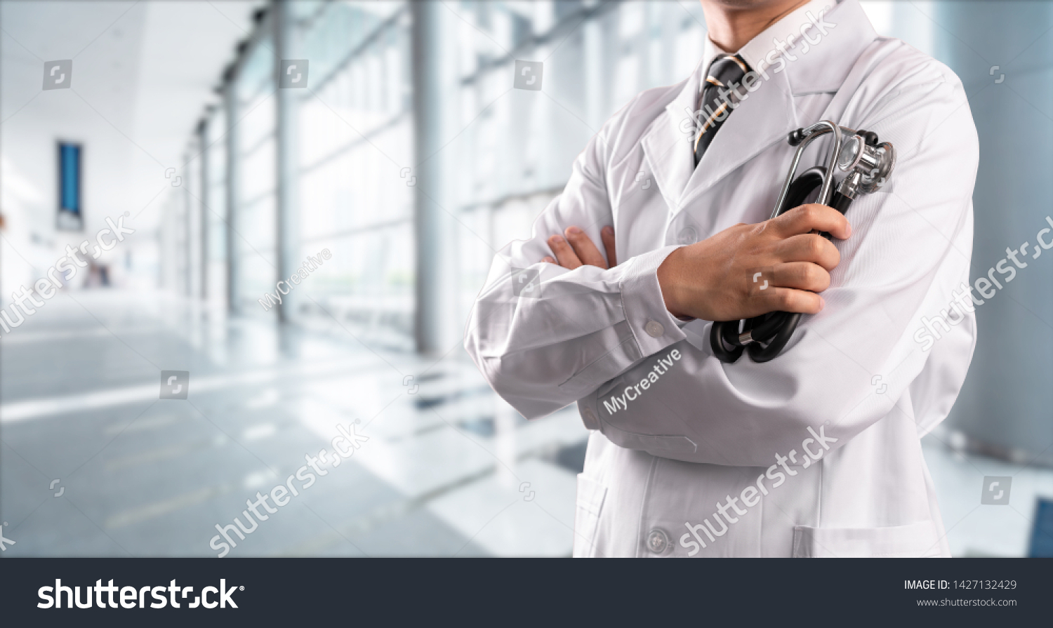 young doctor with hospital background #1427132429