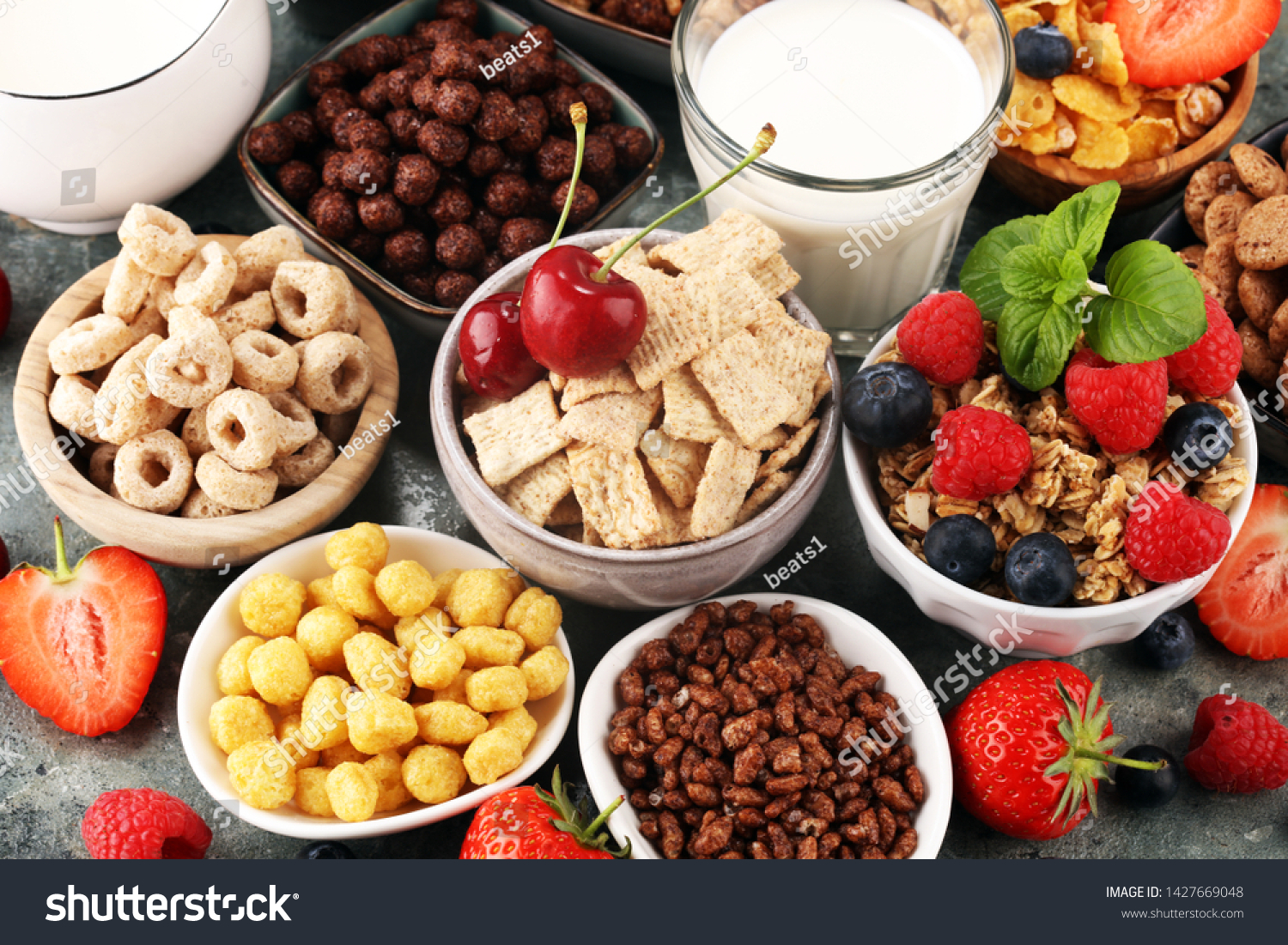 Cereal. Bowls of various cereals, fruits and milk for breakfast. Muesli with variety of kids cereals. #1427669048