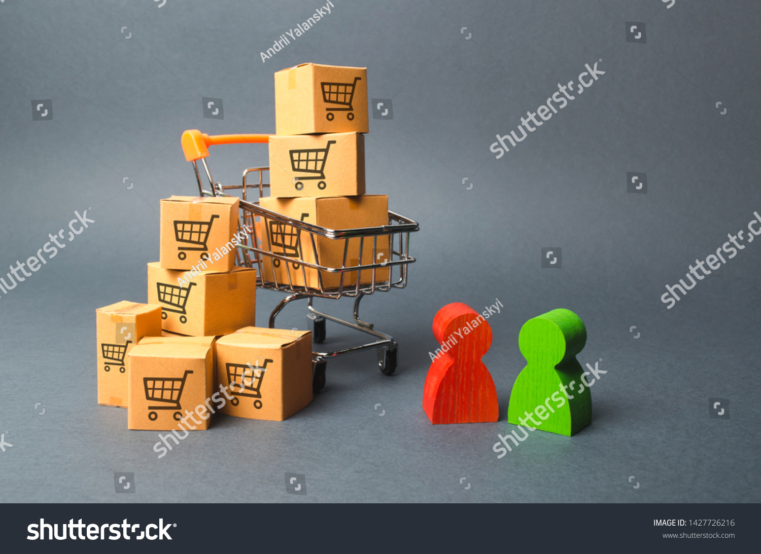 Shopping cart with cardboard boxes with a pattern of trading carts a buyer and seller, manufacturer and retailer. Business and commerce. Negotiations on supply of goods, purchase of goods and services #1427726216