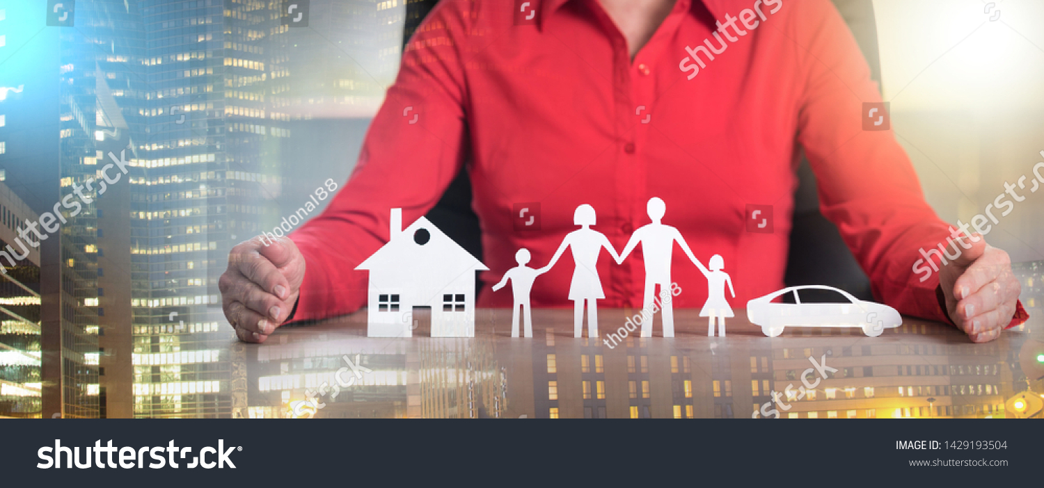 Insurer protecting house, family and car with his hands; multiple exposure #1429193504