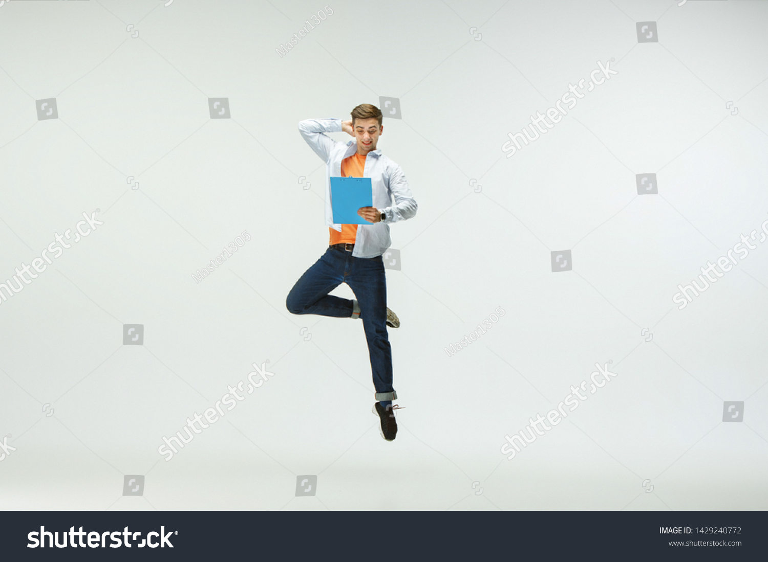 Happy young man working at office, jumping and dancing in casual clothes or suit isolated on white studio background. Business, start-up, working open-space, ballet or professional occupation concept. #1429240772