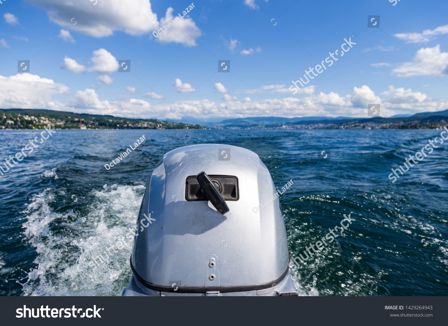 Small motor boat engine close up at full speed on lake Zurich sunny day #1429264943