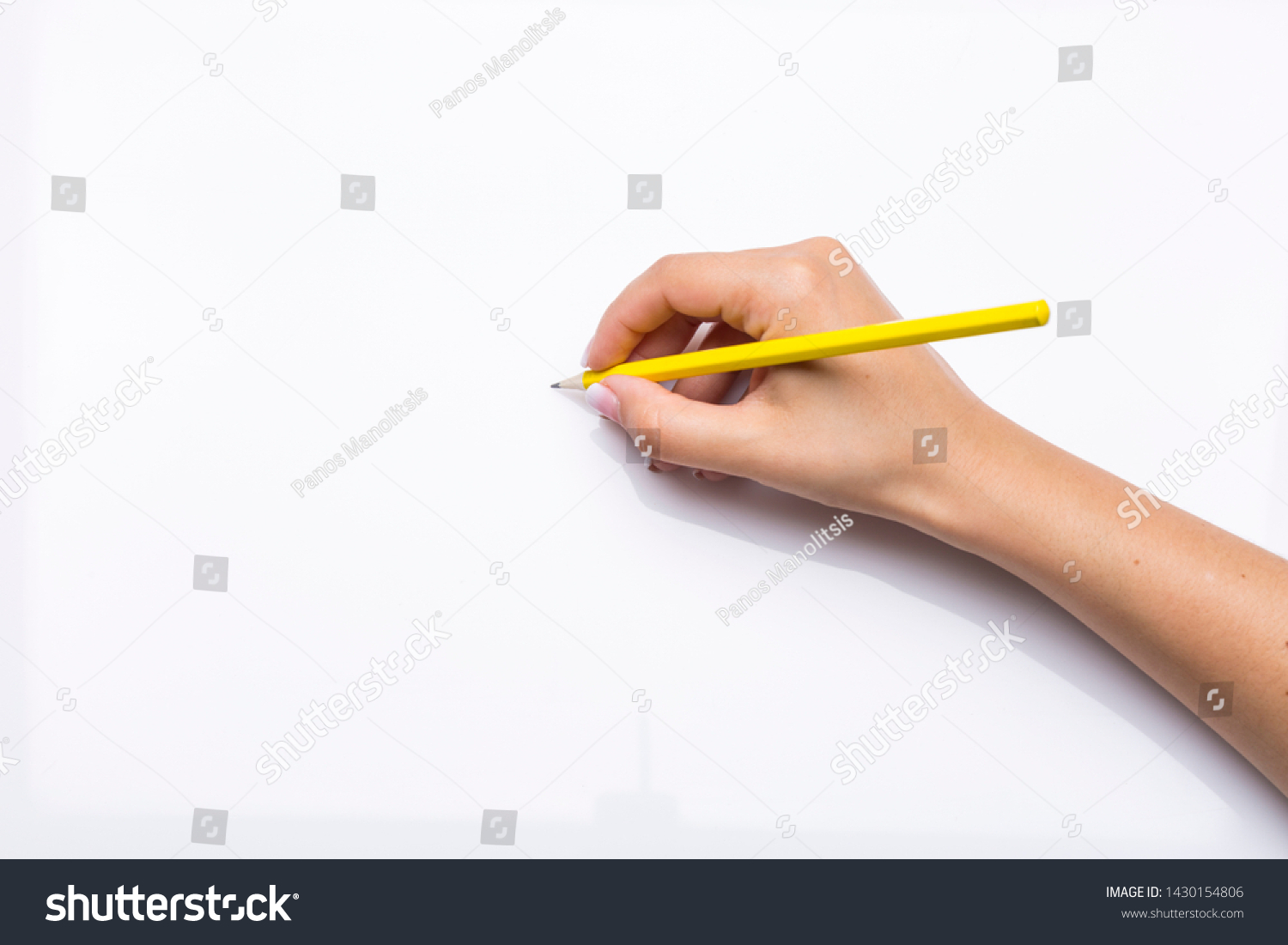 hand holds yellow pencil in blank white background #1430154806