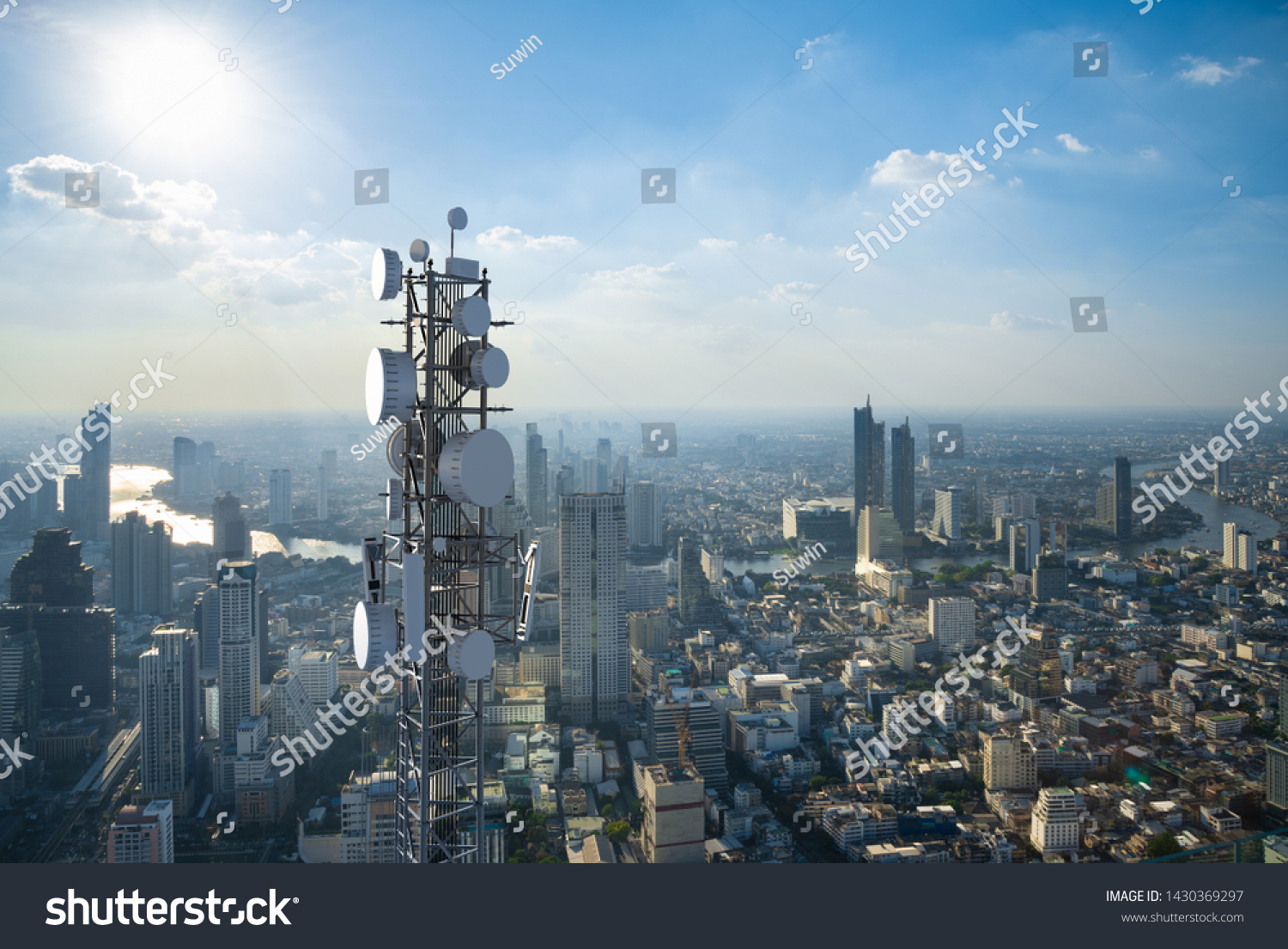 Telecommunication tower with 5G cellular network antenna on city background #1430369297