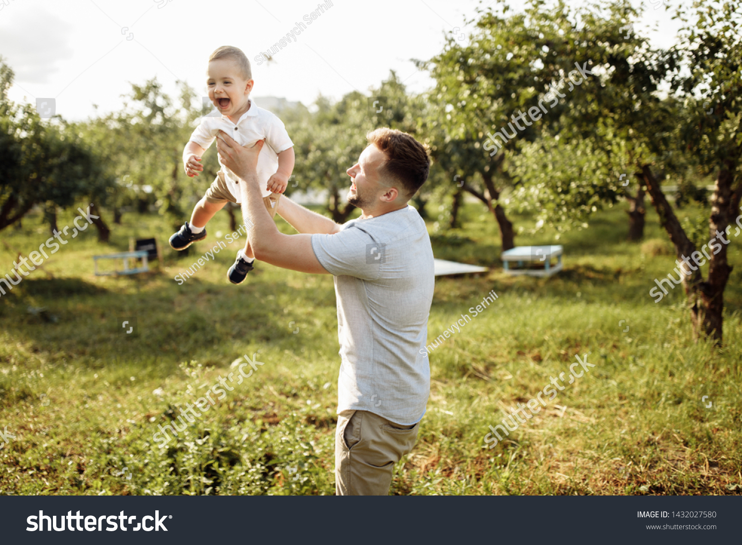 Happy young father with little son play in the park at summer  #1432027580