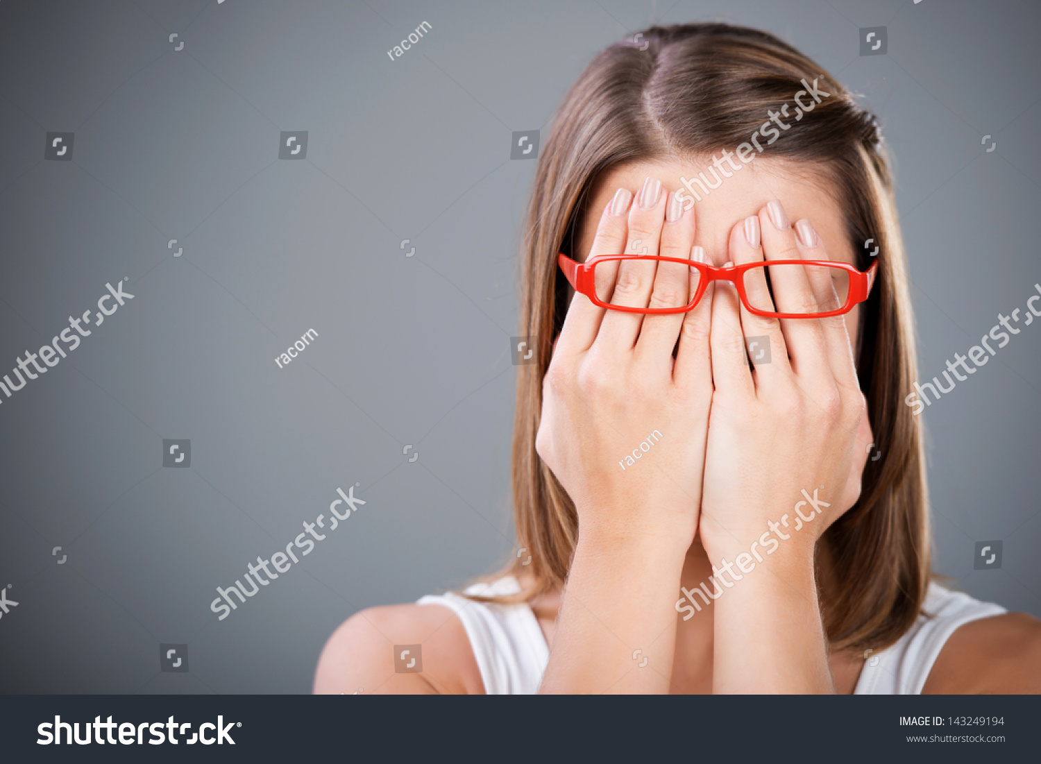 Young brunette woman covering face using her both hands #143249194