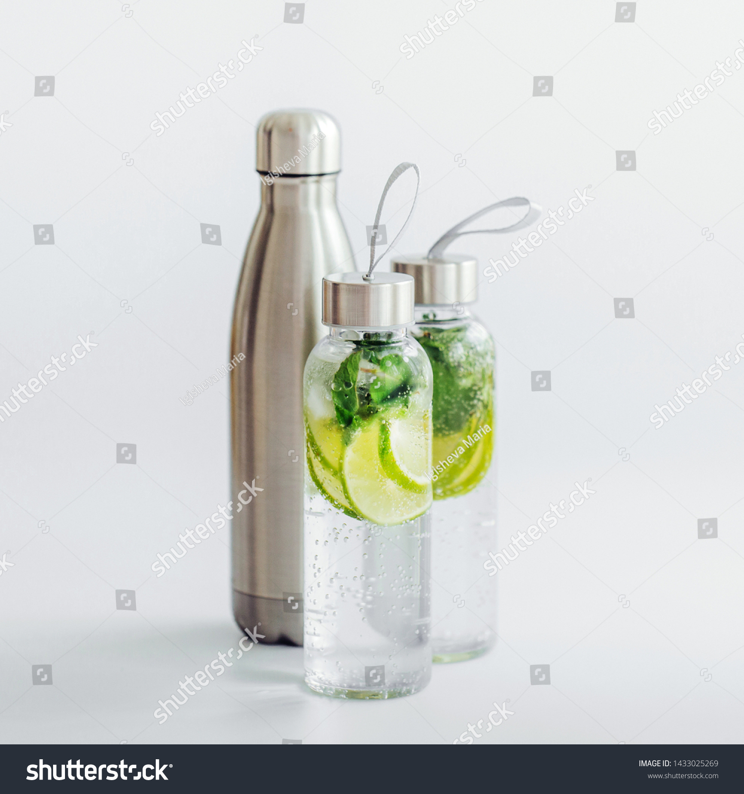 Fresh lime and mint infused water, cocktail, detox drink, lemonade in reusable bottles. Summer drinks. Health care concept. #1433025269