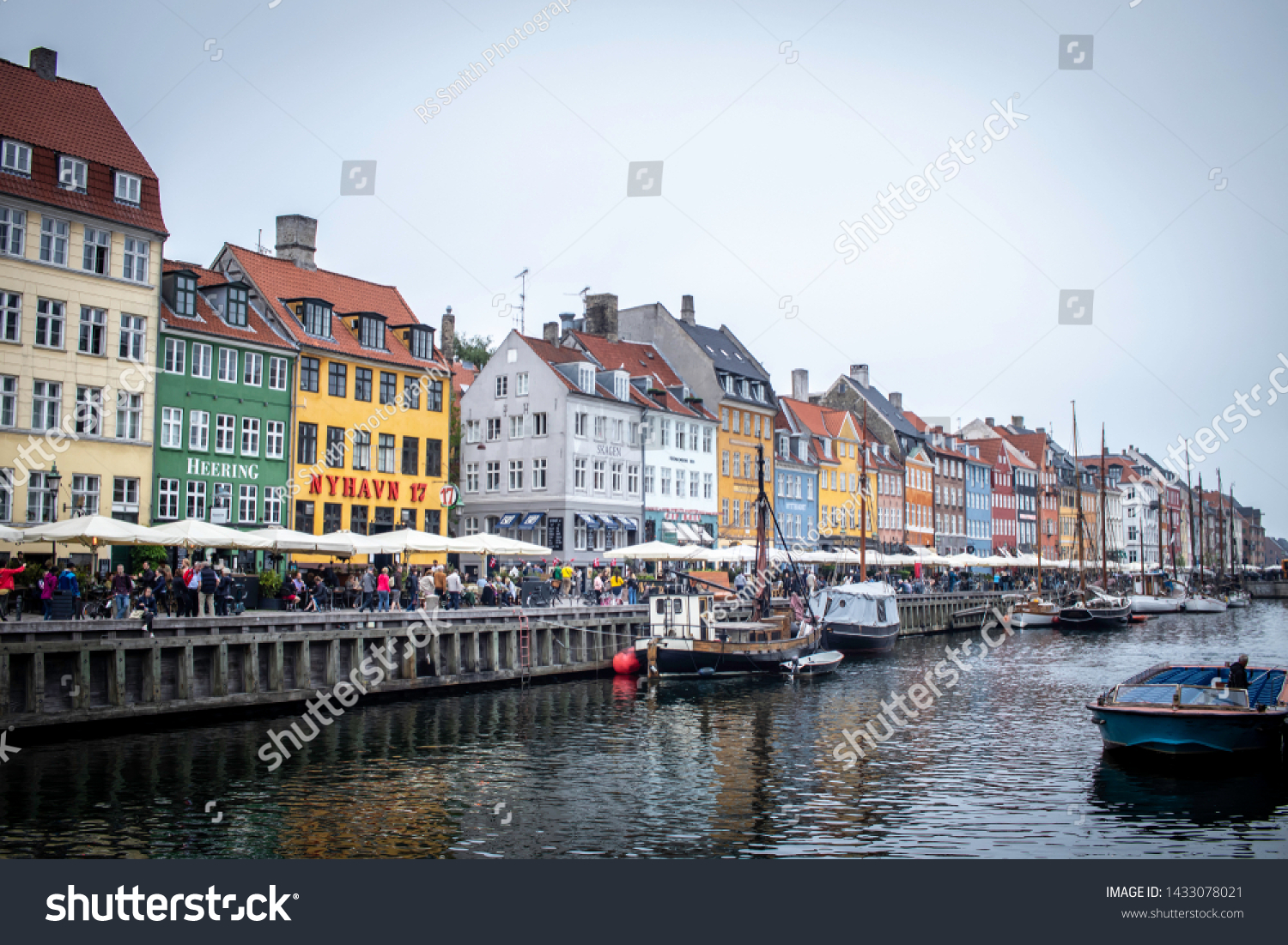 Copenhagen, Denmark-May 22, 2019: The famous Nyhavn canal on a cloudy spring day.  #1433078021