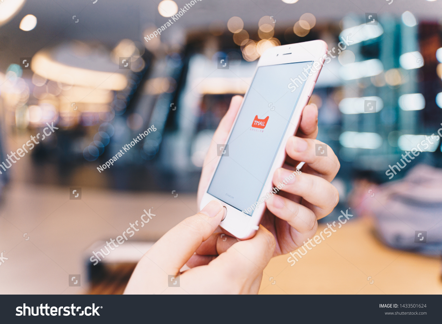 CHIANG MAI, THAILAND - May.10,2019: Woman hands holding Apple iPhone with tmall apps on the screen. #1433501624