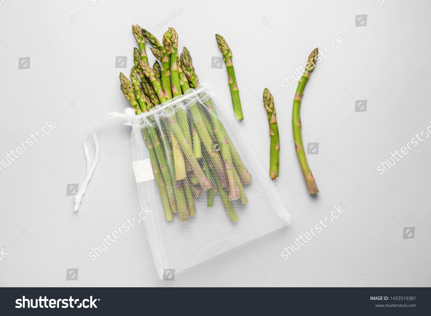 Eco bag with asparagus on light background #1433519381