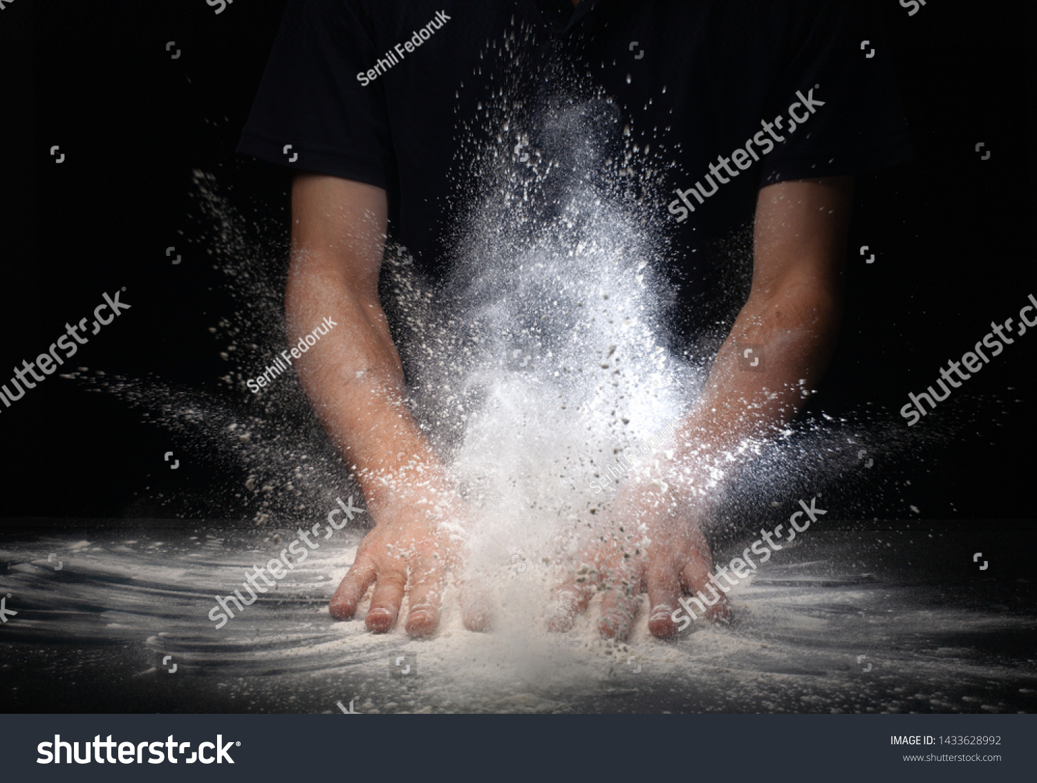 hand clap and white flour on black background . #1433628992