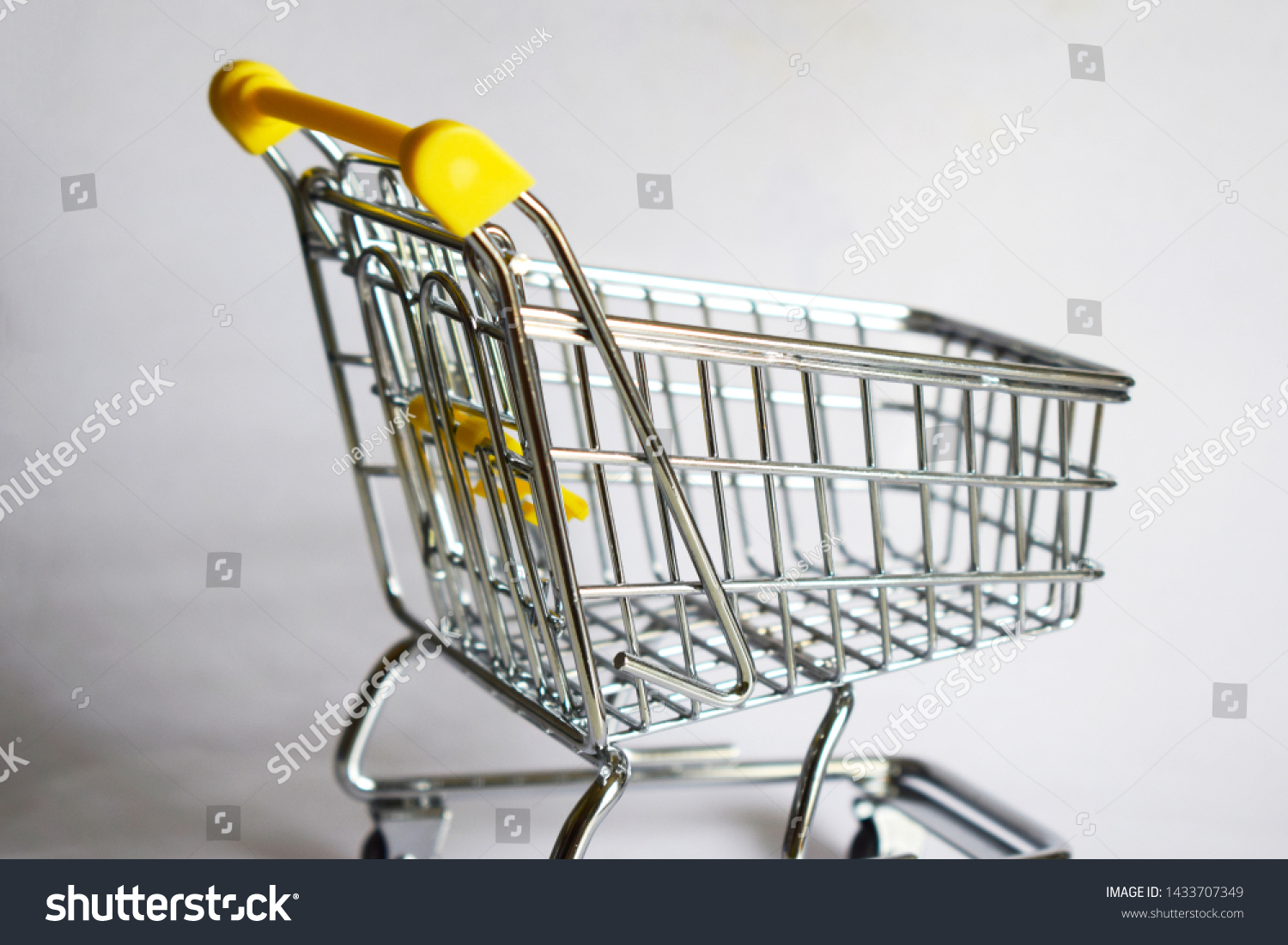 yellow metal shopping trolley whit white background  #1433707349