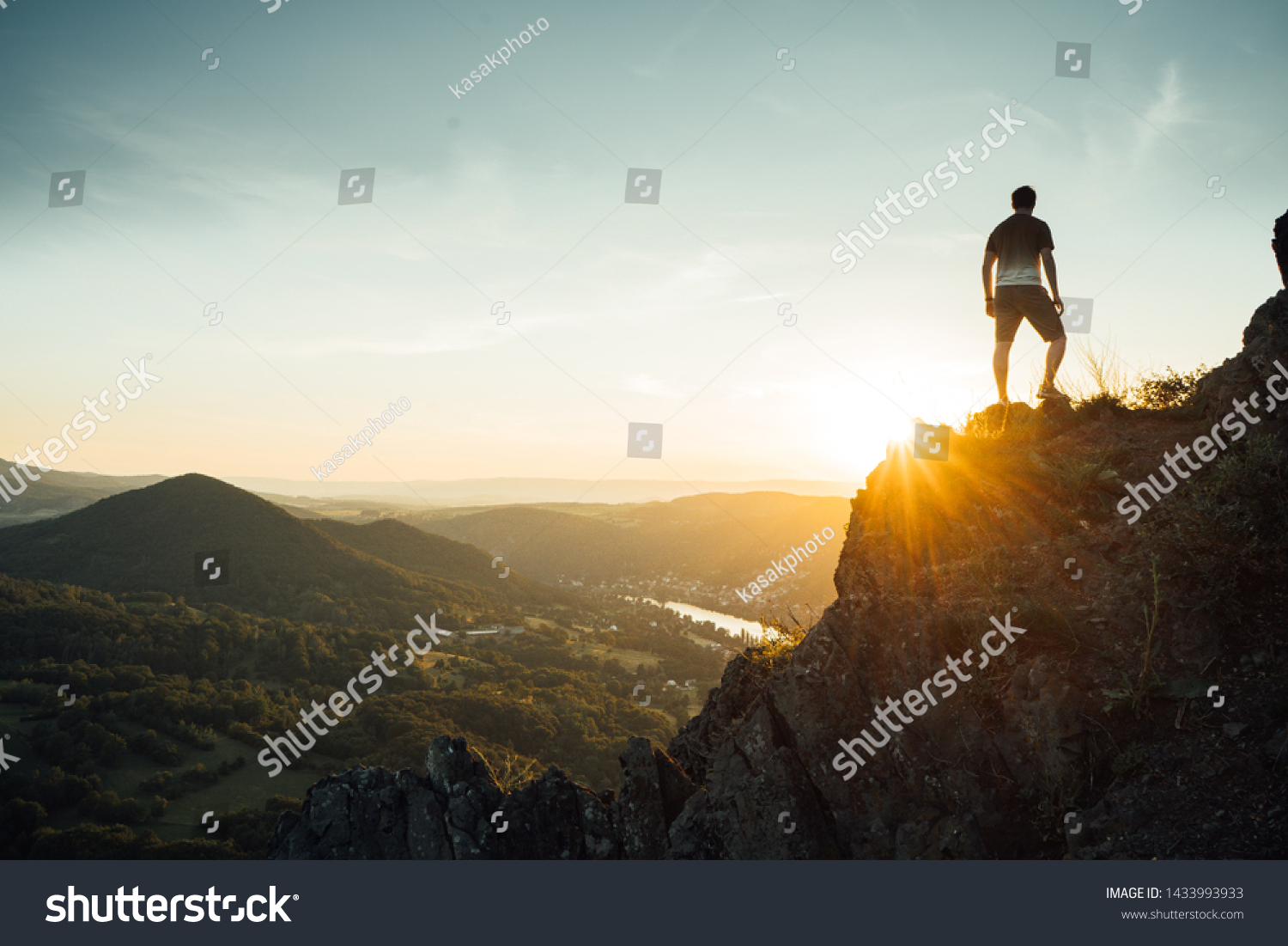 
Silhouette of a man on a mountain top. Person on the rock. Sport and active life concept. Beauty world. Climber on rock face #1433993933