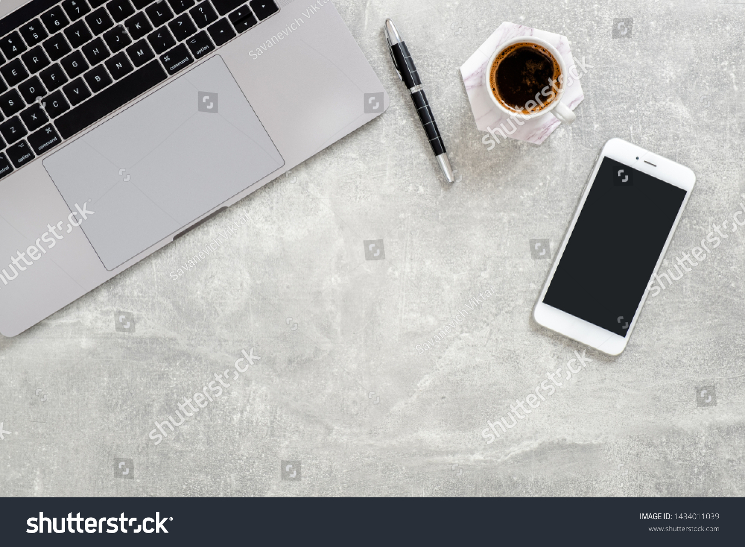 Office desk table with laptop computer,  blank copy space mockup screen smartphone, cup of coffee and supplies on concrete stone background. Top view with copy space, flat lay. #1434011039