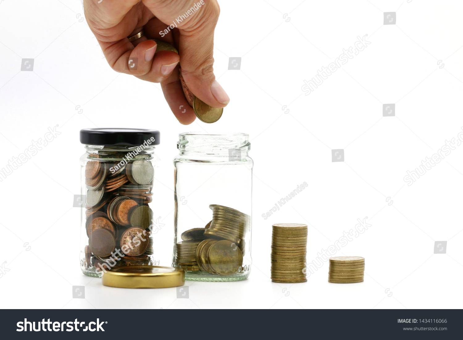 The hand is coin saving,saving in the saving box on white background with copy space. #1434116066