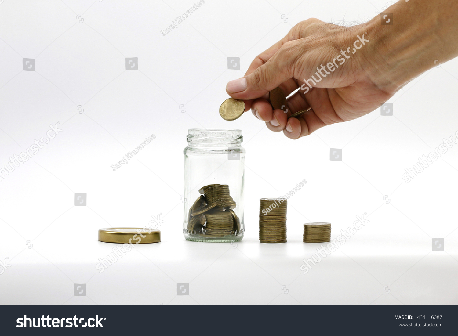 The hand is coin saving,saving in the saving box on white background with copy space. #1434116087