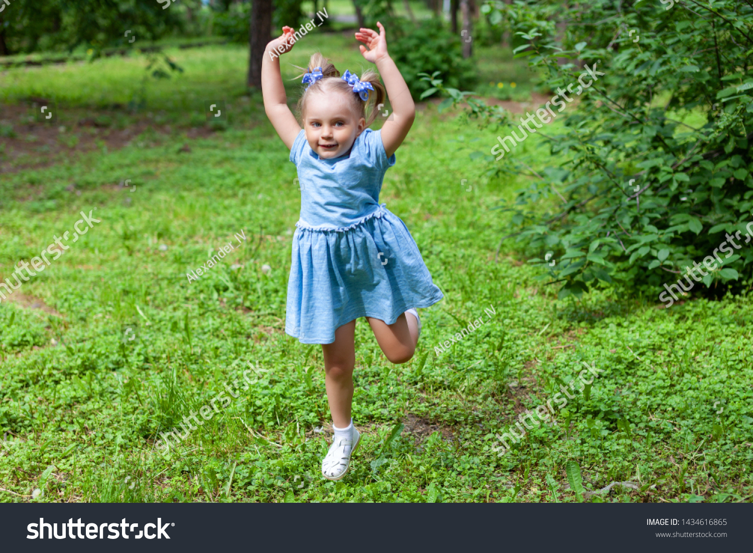 little cheerful girl on a walk in the park #1434616865