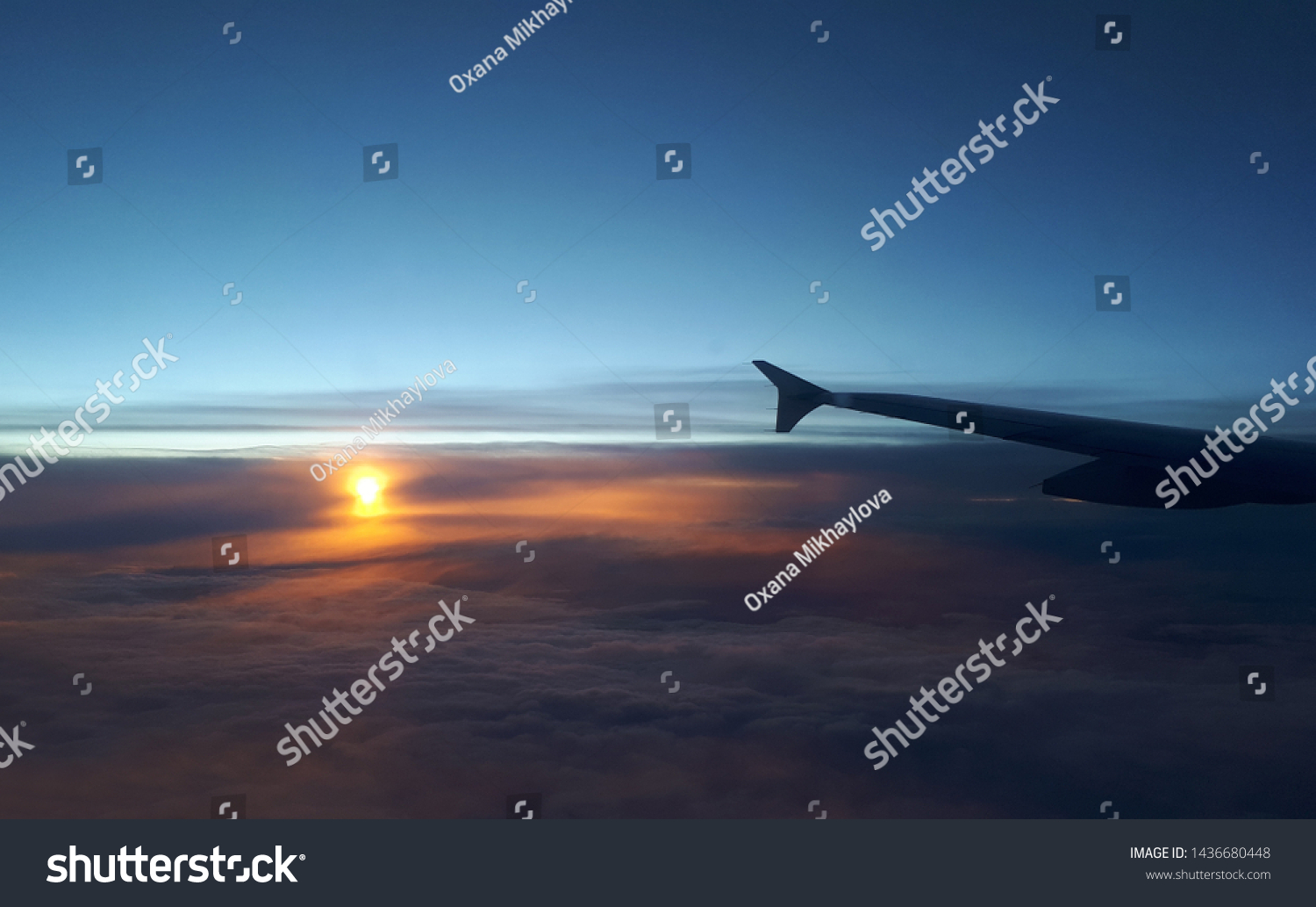 View from airplane. Colorful sunset/sunrise in the sky. #1436680448
