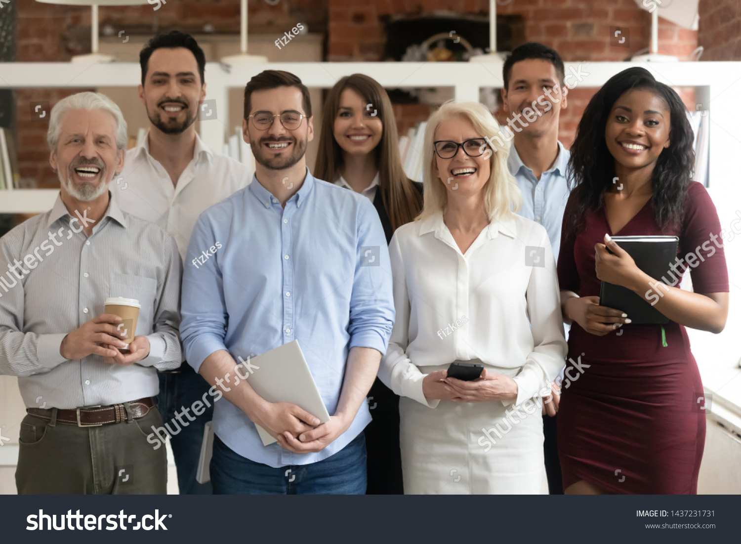 Happy diverse professional business team stand in office looking at camera, smiling young and old multiracial workers staff group pose together as human resource, corporate equality concept, portrait #1437231731