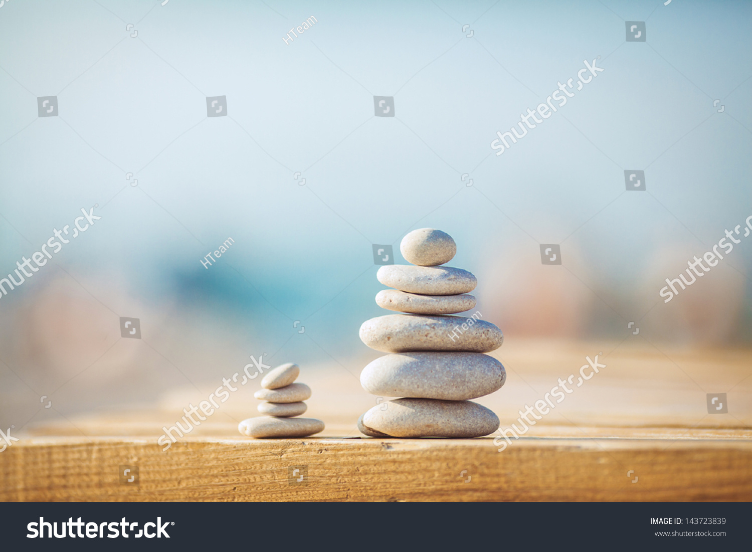 zen stones on wooden banch on the beach near sea. Outdoor. en style path on vintage wood table in relaxing wellness holistic spa for relaxation and good health rejuvenation #143723839